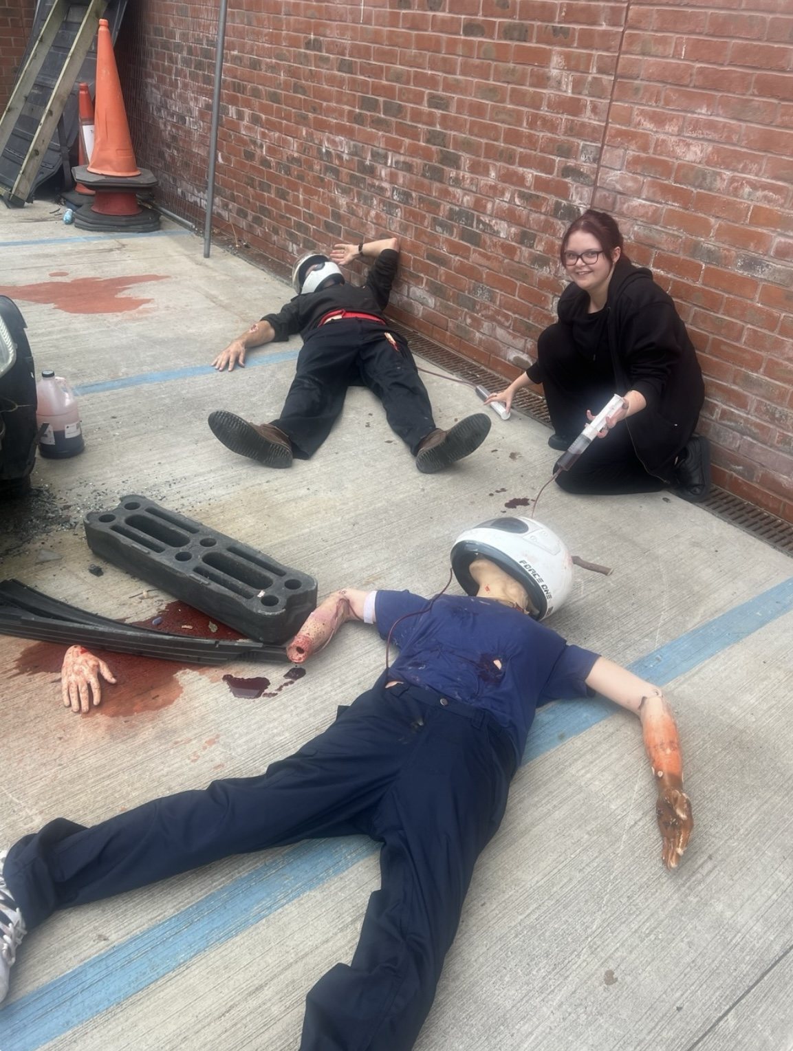 Amy rigging two blood pumps during a fire station trauma simulation